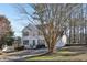 Attractive two-story residence with green shutters, a spacious driveway, and a lush, wooded backdrop at 1056 Shadow Lake Dr, Lithonia, GA 30058