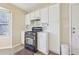 Kitchen featuring white cabinetry, tile backsplash, and gas range at 1056 Shadow Lake Dr, Lithonia, GA 30058