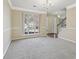 Bright living room with large window, neutral walls, and staircase; perfect for entertaining or relaxing at 1056 Shadow Lake Dr, Lithonia, GA 30058