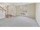 Bright living area with staircase, hardwood floors and light-filled window offering a warm ambiance at 1056 Shadow Lake Dr, Lithonia, GA 30058