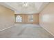 Spacious main bedroom featuring a trey ceiling, ceiling fan, carpet, and natural light at 1056 Shadow Lake Dr, Lithonia, GA 30058