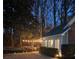 The backyard at night features landscaping lights along a gravel pathway, showing the home's facade at 1203 Cascade Park Sw Dr, Atlanta, GA 30331