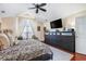 A well lit primary bedroom featuring an entertainment center and luxury finishes at 1203 Cascade Park Sw Dr, Atlanta, GA 30331