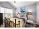 A well lit bedroom featuring a wrought iron bed frame and vaulted ceilings at 1203 Cascade Park Sw Dr, Atlanta, GA 30331