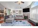 Open living room with fireplace, large windows, and hardwood flooring at 1203 Cascade Park Sw Dr, Atlanta, GA 30331