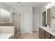 Beautiful bathroom with a glass-enclosed shower, double sink vanity, and neutral tile flooring at 1456 Auburn Glen Rd, Dacula, GA 30019