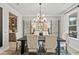 Elegant dining room featuring modern lighting, decor, and a view into the butler's pantry at 1456 Auburn Glen Rd, Dacula, GA 30019