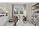 Inviting office space with a large window, stylish lamps, and a decorative shelving unit at 1456 Auburn Glen Rd, Dacula, GA 30019