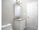 Bright bathroom with granite vanity top, decorative tile floor, and white cabinets at 1798 Giben Rd, Atlanta, GA 30315