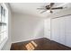 Neutral bedroom featuring hardwood floors, a ceiling fan, and white closets at 1798 Giben Rd, Atlanta, GA 30315