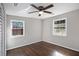 Bedroom featuring hardwood floors, two windows and a ceiling fan at 1798 Giben Rd, Atlanta, GA 30315
