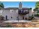 Exterior view of the home's back, featuring a raised deck and concrete patio at 2425 Pemberton Pt, Buford, GA 30519