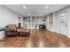 Large basement with custom built-in bookshelves, recessed lights, and a leather couch set at 2425 Pemberton Pt, Buford, GA 30519