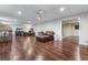 Spacious finished basement area with hardwood floors, comfortable seating, and bedroom area at 2425 Pemberton Pt, Buford, GA 30519