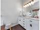 Elegant bathroom with a double sink vanity, sleek countertops, and a large framed mirror at 2425 Pemberton Pt, Buford, GA 30519