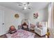 Charming bedroom with a modern ceiling fan, ' tent, and a comfortable sitting chair at 2425 Pemberton Pt, Buford, GA 30519