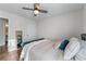 Cozy bedroom featuring a comfy bed with decorative pillows and a modern ceiling fan at 2425 Pemberton Pt, Buford, GA 30519