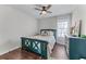 Inviting bedroom with a decorative ceiling, a bed with green wood trim, and rich hardwood floors at 2425 Pemberton Pt, Buford, GA 30519