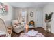 Cozy Bedroom featuring a recliner, soft rug, and natural light at 2425 Pemberton Pt, Buford, GA 30519