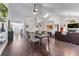 Open-concept dining room features a modern table, chairs and an elegant light fixture at 2425 Pemberton Pt, Buford, GA 30519