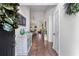 Warm entryway featuring hardwood floors, a decorative table, and a glimpse into the living spaces at 2425 Pemberton Pt, Buford, GA 30519