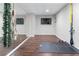 Bright home gym featuring a mirrored wall, wood floor, and space for exercise equipment at 2425 Pemberton Pt, Buford, GA 30519