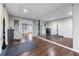 Bright home gym featuring a mirrored wall, wood floor, and an open area leading to the house at 2425 Pemberton Pt, Buford, GA 30519