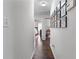 Well-lit hallway featuring hardwood floors and gallery wall at 2425 Pemberton Pt, Buford, GA 30519
