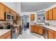 Well-equipped kitchen with stainless steel appliances and wood cabinets at 2425 Pemberton Pt, Buford, GA 30519