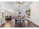 Spacious open-plan dining and living area with hardwood floors and plenty of seating at 2425 Pemberton Pt, Buford, GA 30519