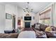 Cozy living room featuring a comfortable leather couch, decorative pillows, and stylish lighting at 2425 Pemberton Pt, Buford, GA 30519