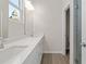 Bathroom featuring double vanity, quartz counters, white cabinetry, and large mirror with modern lighting at 108 Black Gum Unit 38 Ln, Auburn, GA 30011