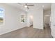 Large primary bedroom featuring neutral paint, modern ceiling fan and LVP flooring leading to ensuite bathroom at 108 Black Gum Unit 38 Ln, Auburn, GA 30011