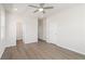 Large primary bedroom featuring neutral paint, modern ceiling fan and LVP flooring leading to ensuite bathroom at 108 Black Gum Unit 38 Ln, Auburn, GA 30011