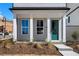 Close up of front entrance with a vibrant green door, neat landscaping, and inviting curb appeal at 108 Black Gum Unit 38 Ln, Auburn, GA 30011