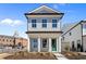 Charming two-story home with a manicured front yard and a striking green front door at 108 Black Gum Unit 38 Ln, Auburn, GA 30011