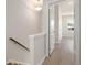 Upstairs hallway with a light fixture, hardwood floors and bright white walls, leading to multiple bedrooms at 108 Black Gum Unit 38 Ln, Auburn, GA 30011