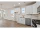 Contemporary kitchen with white cabinets, stainless steel appliances, and ample counter space at 108 Black Gum Unit 38 Ln, Auburn, GA 30011