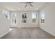 Sun-filled living room features light wood floors, neutral walls, and multiple windows for natural light at 108 Black Gum Unit 38 Ln, Auburn, GA 30011