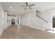 Bright, open-concept living space features light wood floors, a modern ceiling fan, and staircase at 108 Black Gum Unit 38 Ln, Auburn, GA 30011