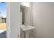Bright powder room features a pedestal sink, framed mirror and neutral paint with an outside view at 108 Black Gum Unit 38 Ln, Auburn, GA 30011