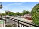 Balcony view overlooking a street with shops, trees, and blue sky at 201 W Ponce De Leon Ave # 315, Decatur, GA 30030