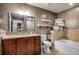 Bathroom featuring vanity with granite countertop, tiled bathtub, and a toilet at 201 W Ponce De Leon Ave # 315, Decatur, GA 30030