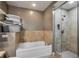 Bathroom showcasing a bathtub with tile surround and a glass-enclosed shower at 201 W Ponce De Leon Ave # 315, Decatur, GA 30030