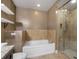 Bathroom with a tiled shower, soaking tub, and vanity with shelving at 201 W Ponce De Leon Ave # 315, Decatur, GA 30030