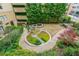 Picturesque aerial view of courtyard featuring water feature and lush landscaping at 201 W Ponce De Leon Ave # 315, Decatur, GA 30030
