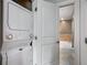 Laundry area with a stacked washer and dryer unit and access to the bathroom at 201 W Ponce De Leon Ave # 315, Decatur, GA 30030