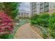 Scenic walking path winds through a lush garden with rocks and colorful flowers near a building at 201 W Ponce De Leon Ave # 315, Decatur, GA 30030