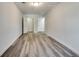 View of the finished basement with gray wood-look flooring, white painted walls, and access to other rooms at 2216 Marbut Farms Trce, Lithonia, GA 30058