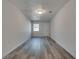 View of the finished basement with gray wood-look flooring, white painted walls, and a single window at 2216 Marbut Farms Trce, Lithonia, GA 30058